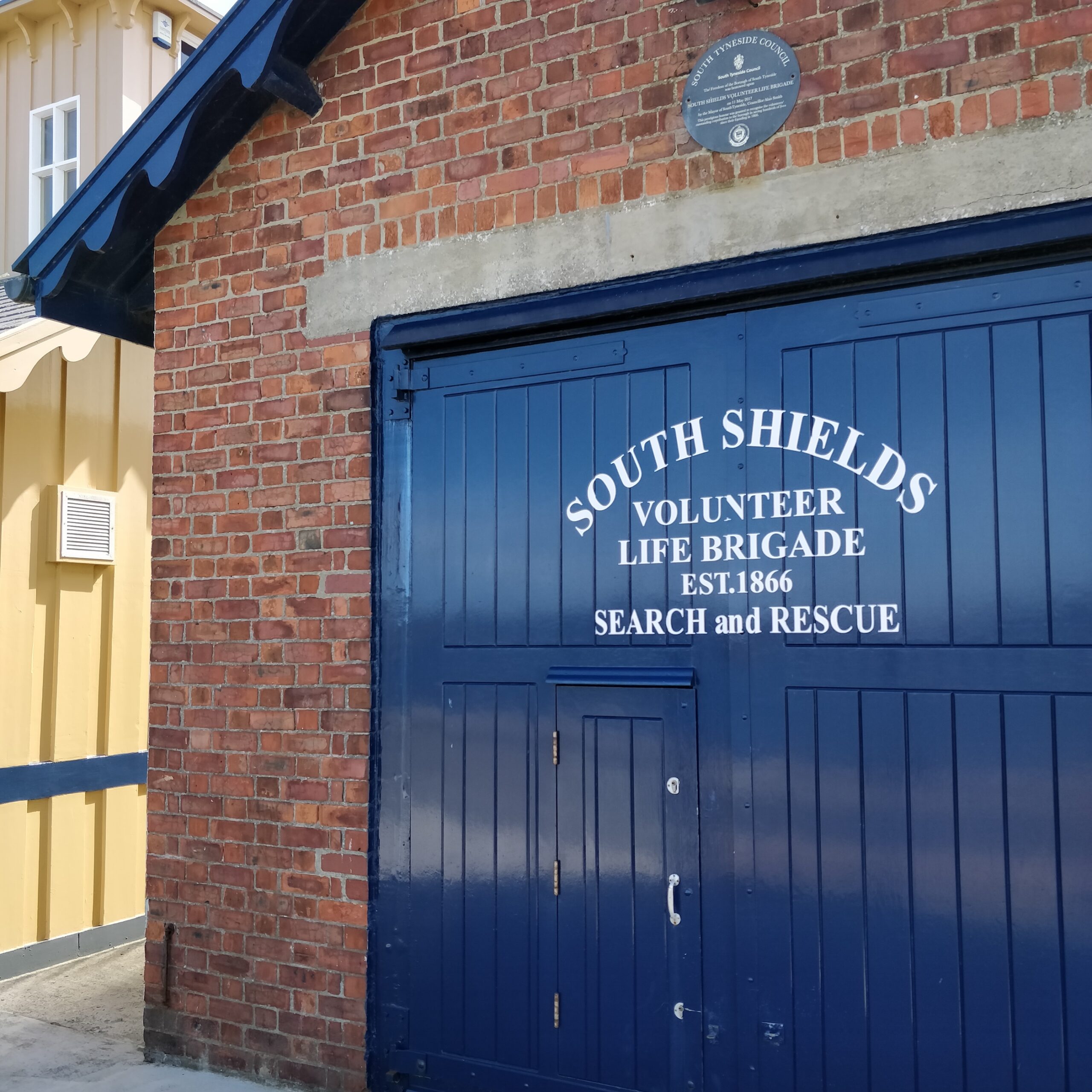 A picture of the blue boat house door of South Shields Volunteer Life Brigade, located on the pier in South Shields